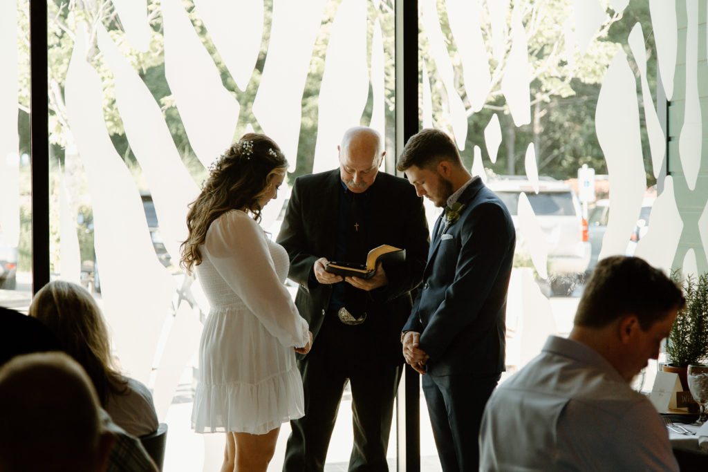 Intimate Wedding Ceremony in The Wine Room at The Grove Kitchens + Garden in Tyler, Texas captured by Lizzie Hillard Photography.