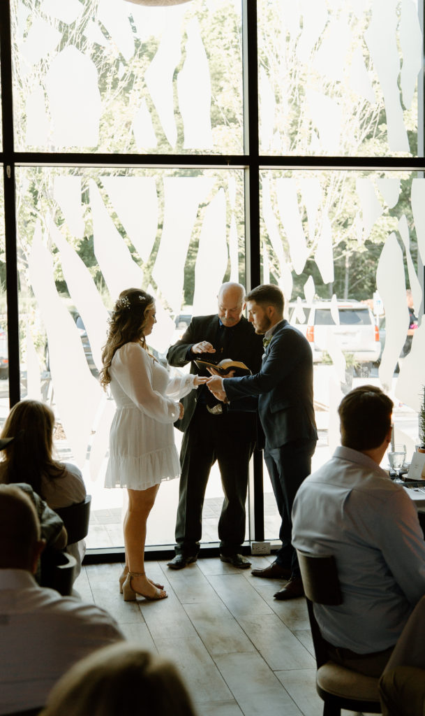 Intimate Wedding Ceremony in The Wine Room at The Grove Kitchens + Garden in Tyler, Texas captured by Lizzie Hillard Photography.