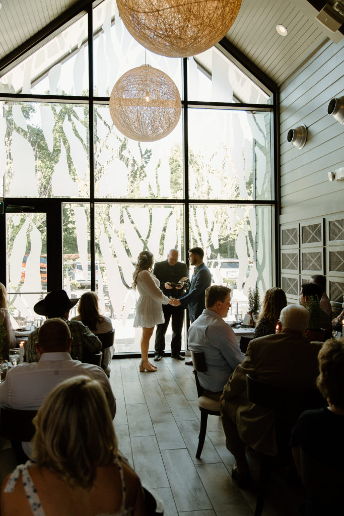 Intimate Wedding Ceremony in The Wine Room at The Grove Kitchens + Garden in Tyler, Texas captured by Lizzie Hillard Photography.