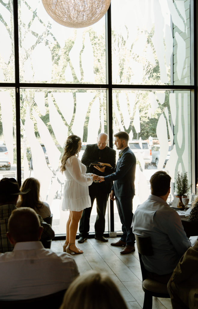 Intimate Wedding Ceremony in The Wine Room at The Grove Kitchens + Garden in Tyler, Texas captured by Lizzie Hillard Photography.