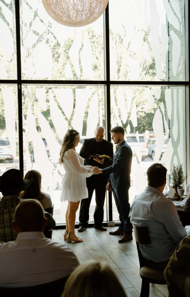 Intimate Wedding Ceremony in The Wine Room at The Grove Kitchens + Garden in Tyler, Texas captured by Lizzie Hillard Photography.