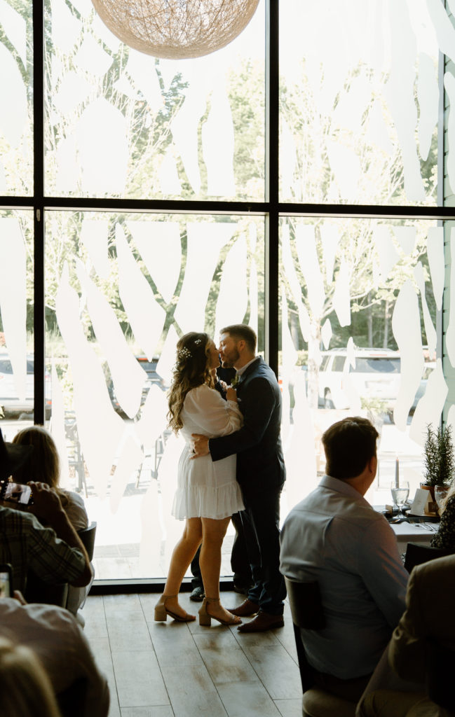 Intimate Wedding Ceremony in The Wine Room at The Grove Kitchens + Garden in Tyler, Texas captured by Lizzie Hillard Photography.