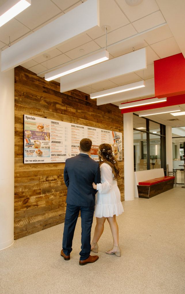 Bride and Groom's Portraits in Downtown Tyler, Texas for Intimate Wedding Day captured by Lizzie Hillard Photography. Ice cream at Andy's on the Tyler, Texas Square.