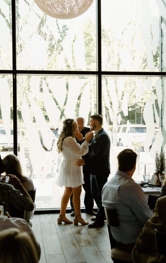 Intimate Wedding Ceremony in The Wine Room at The Grove Kitchens + Garden in Tyler, Texas captured by Lizzie Hillard Photography.