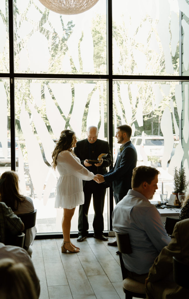 Intimate Wedding Ceremony in The Wine Room at The Grove Kitchens + Garden in Tyler, Texas captured by Lizzie Hillard Photography.