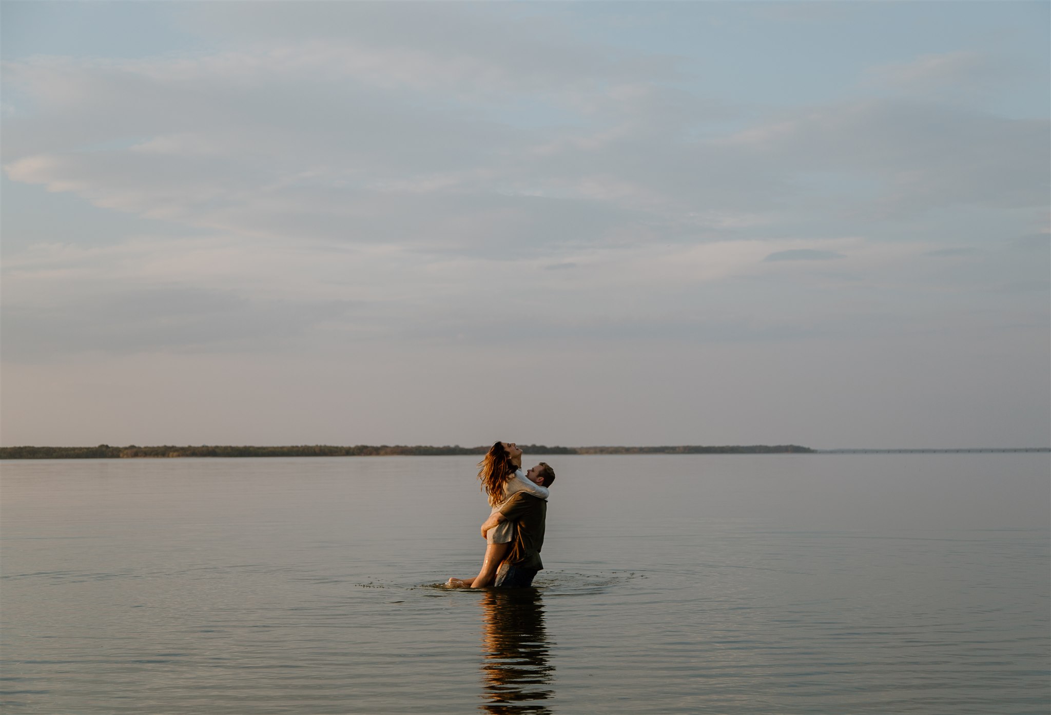 Couple spinning in Lake Tawakoni during engagement photos.