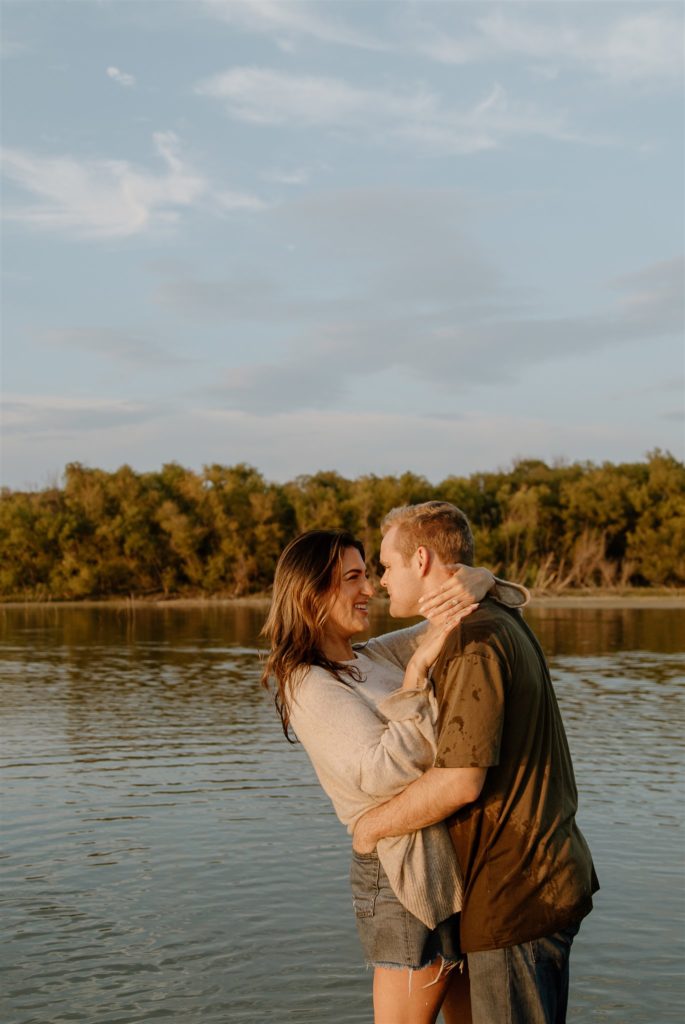 Couple laughing with each other during engagement photos at Lake Tawakoni 