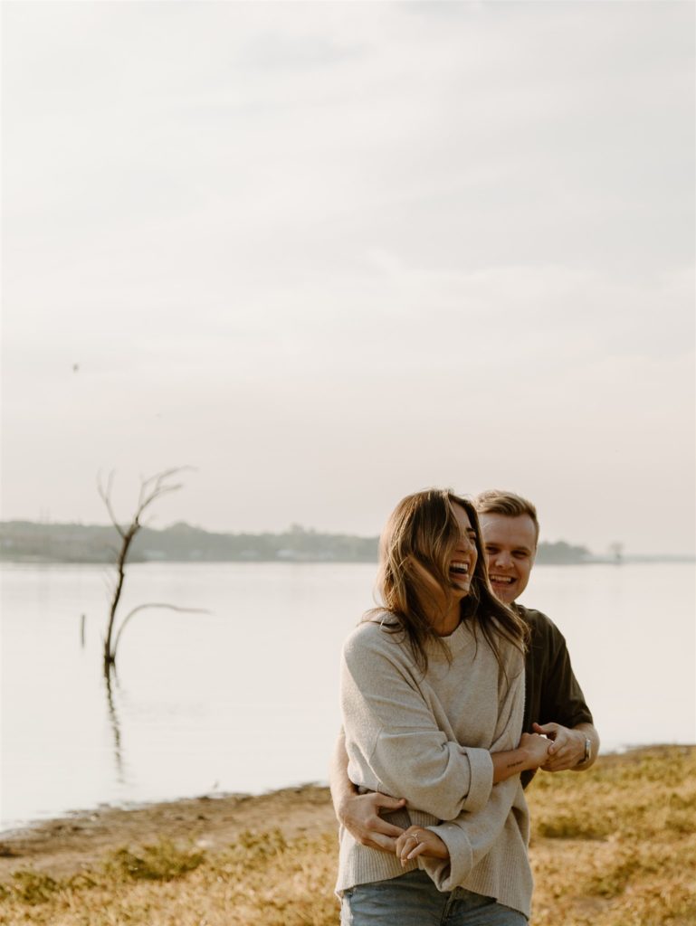 Couple laughs during engagement photos in Canton, Texas.