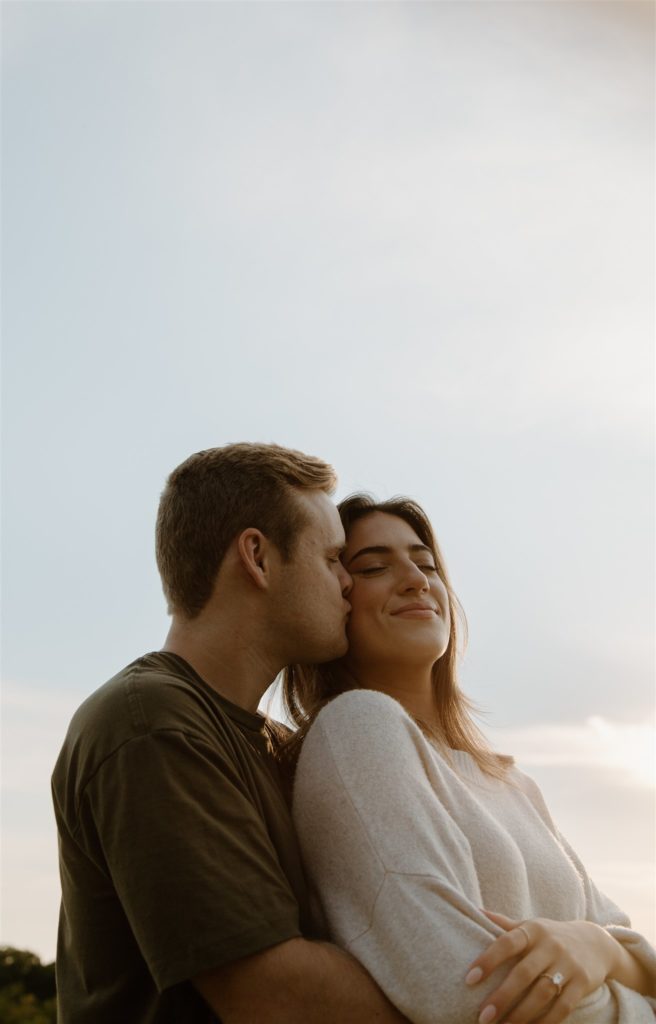 Couple embraces during engagement session at Texas state park.