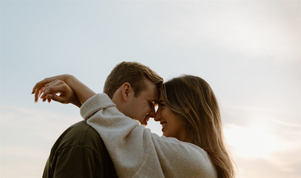 Couple is forehead to forehead during engagement photos in Canton, Texas