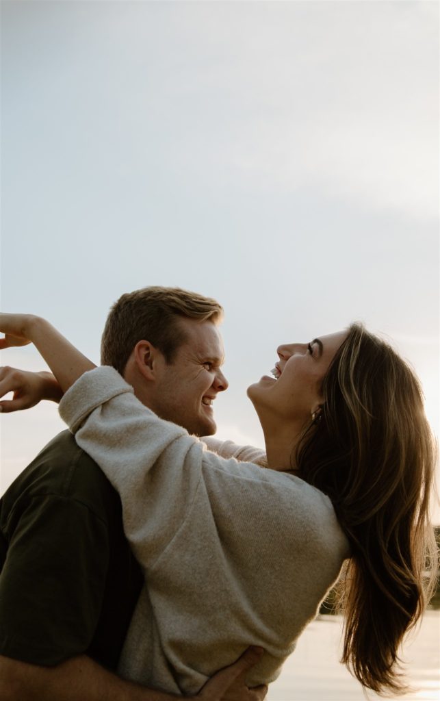 Couple laughing at engagement shoot at Lake Tawakoni State Park.