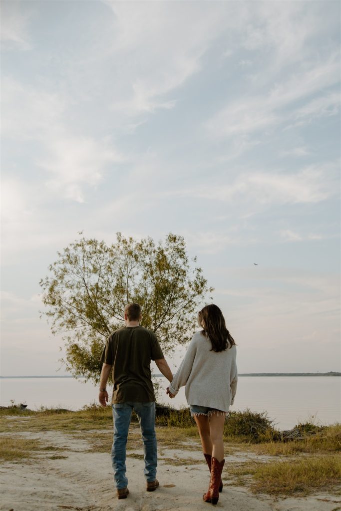 Couple holding hands during engagement photos at Lake Tawakoni State Park.