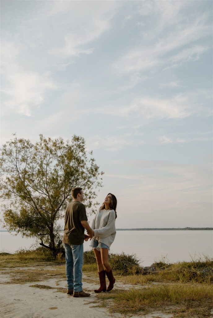 Couple laughing during engagement photos at Lake Tawakoni State Park.