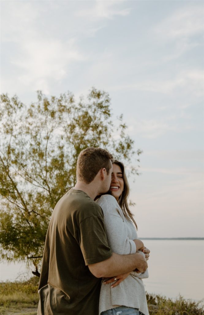 Couple embracing during engagement photos at Lake Tawakoni State Park.