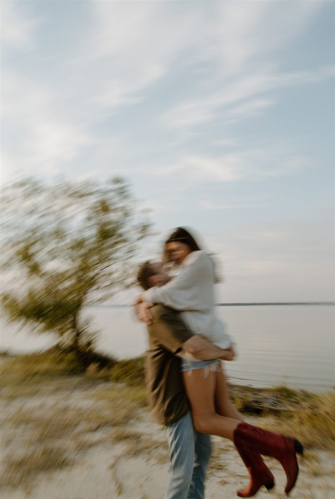 Motion blur of couple spinning during engagement photos at Lake Tawakoni State Park.