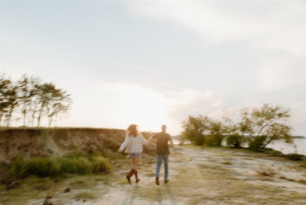 Motion blur of couple running during engagement photos at Lake Tawakoni State Park.