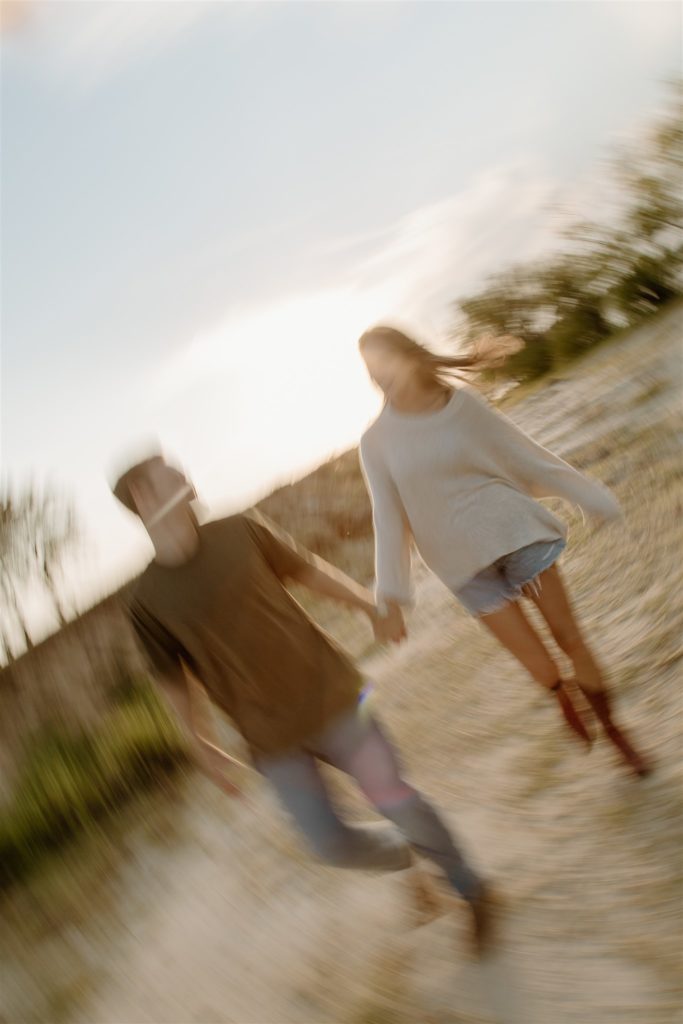 Couple engagement photos prompts during motion blur.