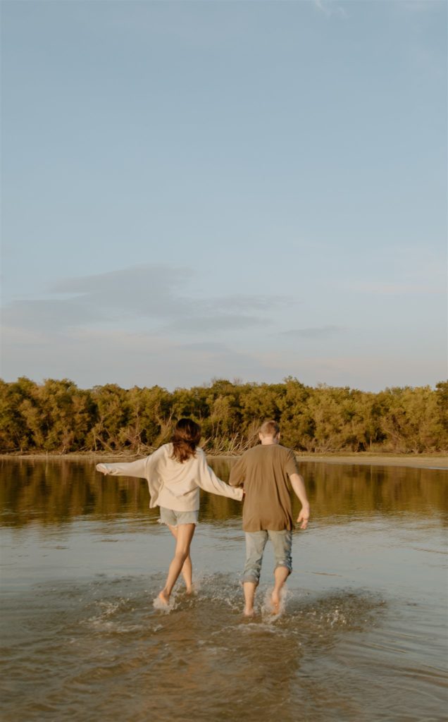 Couple running through the water at Lake Tawakoni State Park.