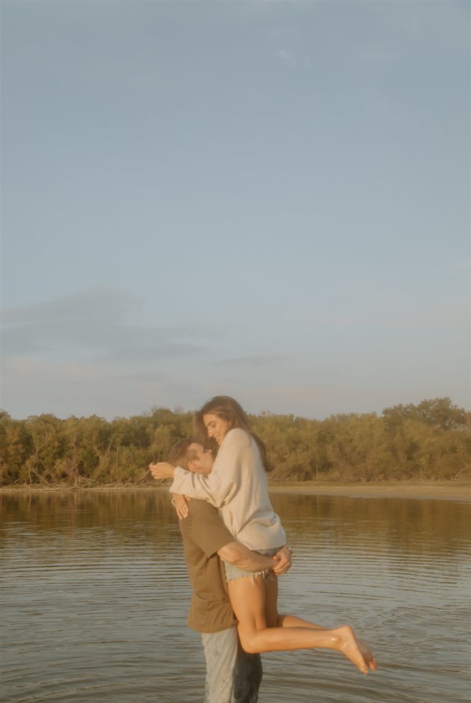 Couple in water at Lake Tawakoni State Park during engagement photos.