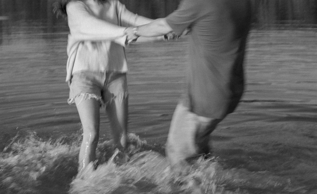 Details of couple spinning around in lake motion blur.