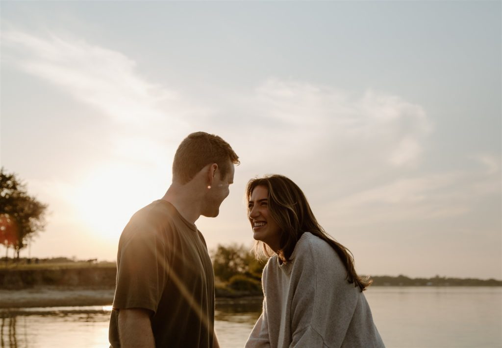 Couple talking during golden hour engagement photos.