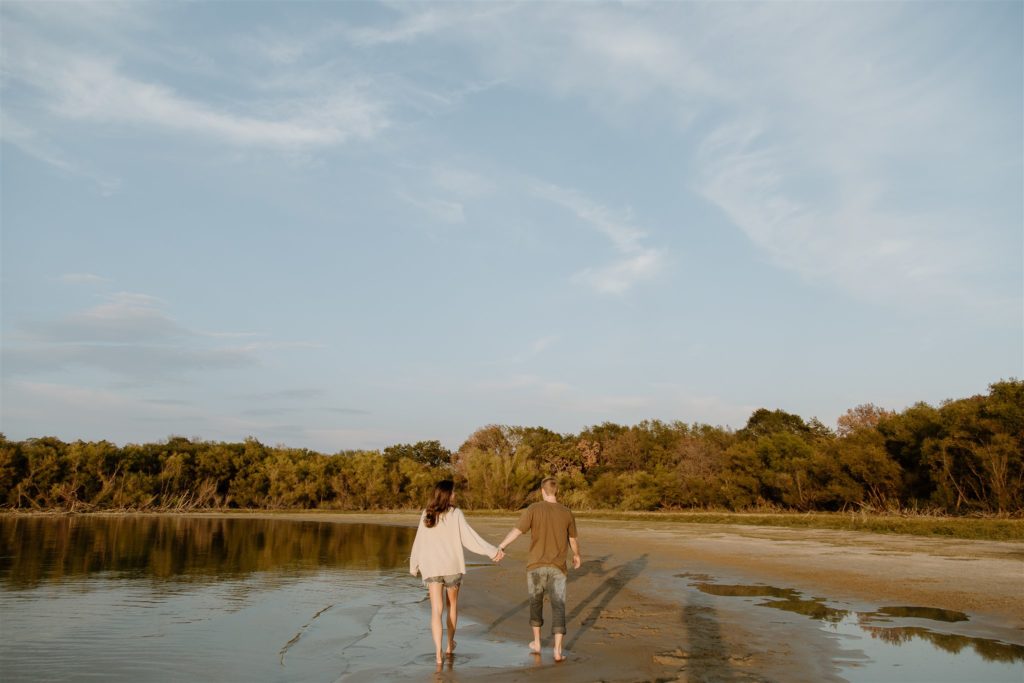 Couple walking on beach at Lake Tawakoni State Park.