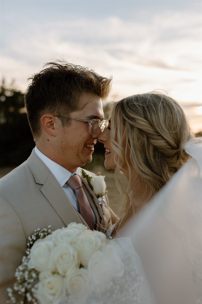 Close up of bride and groom touching noses and smiling after texas wedding.