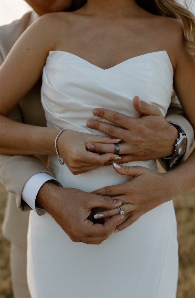 Bride and groom place wedding rings on each other's fingers during texas wedding ceremony.