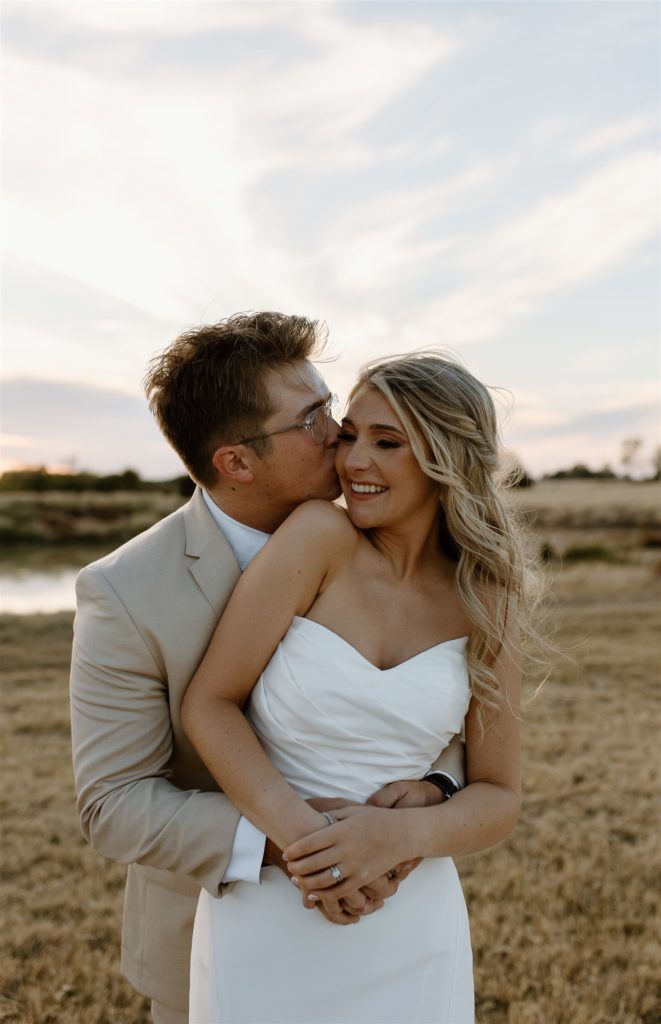 Bride and groom laugh during texas wedding portraits.