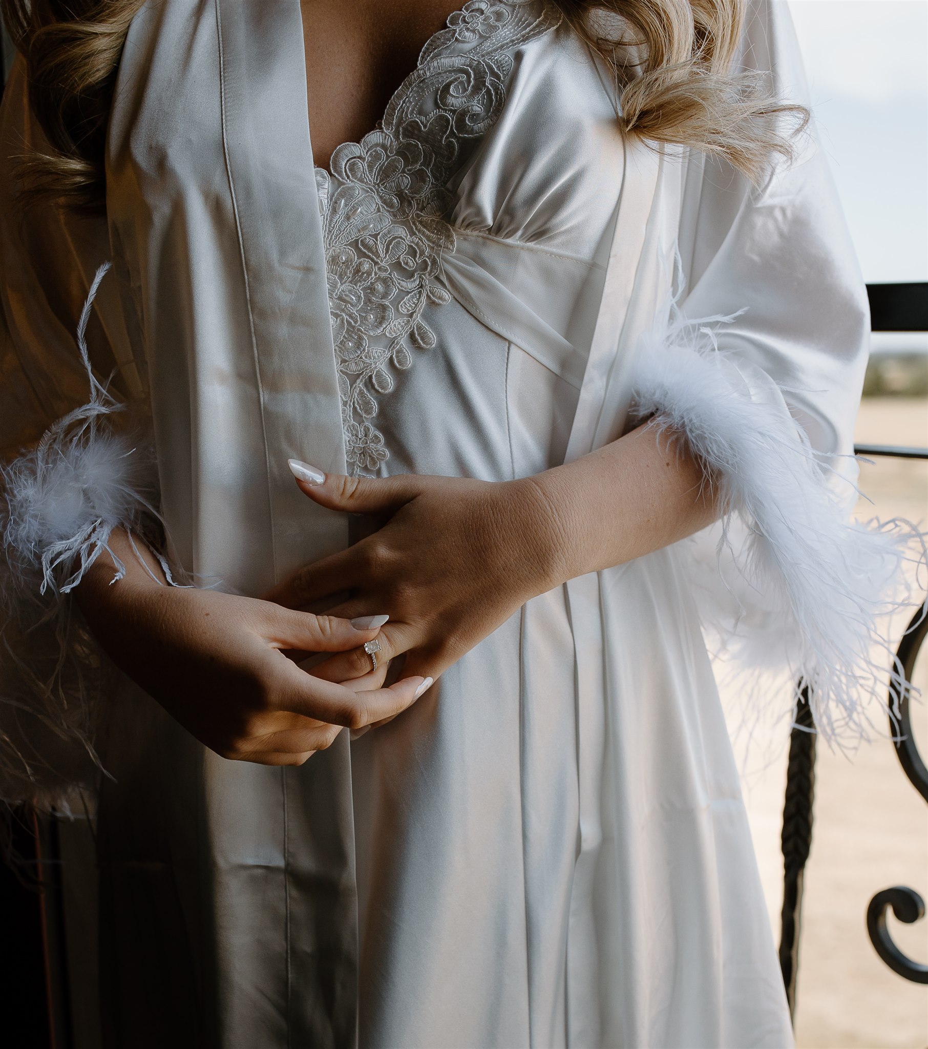 Bridal details with engagement ring and getting ready attire.