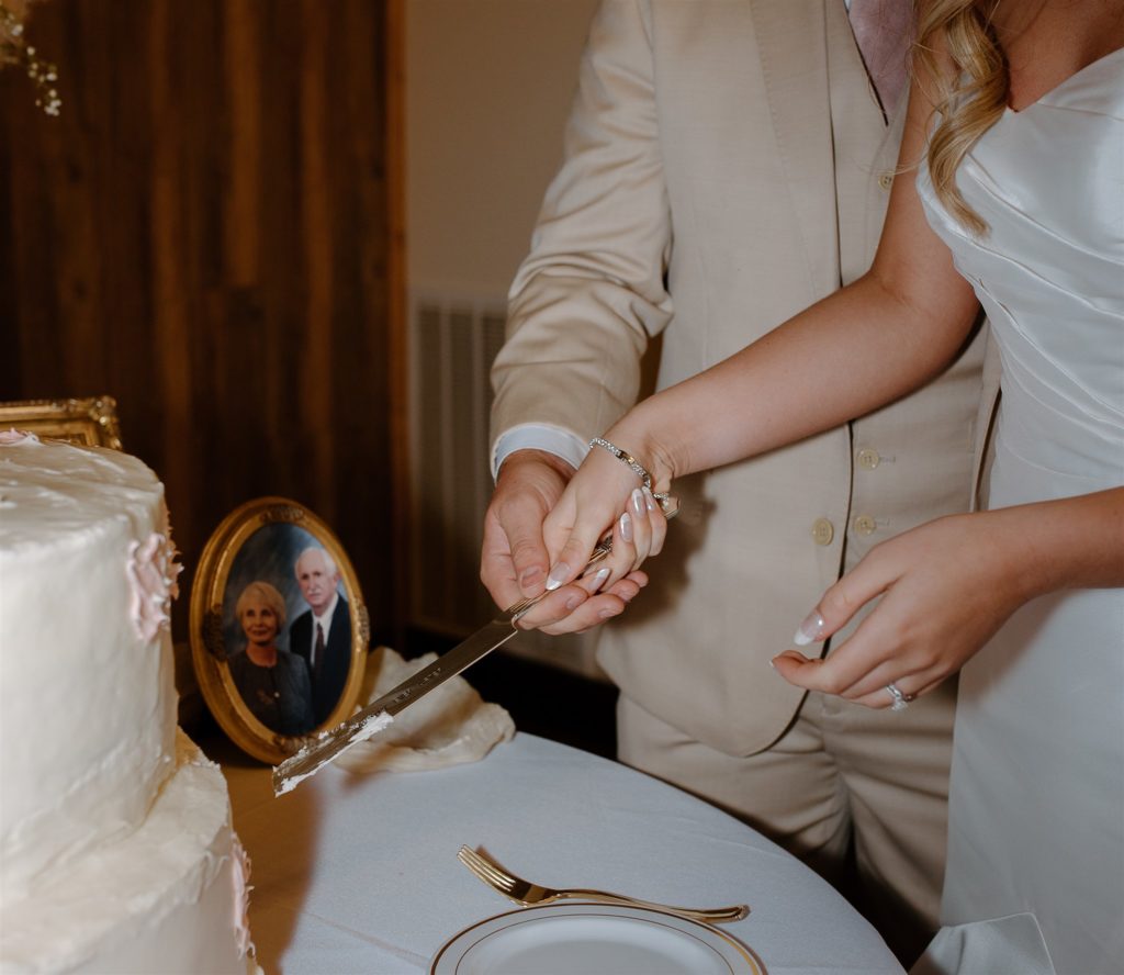 Details of bride and groom cutting the cake at texas wedding reception.