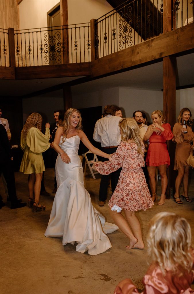 Bride and guests dance during texas wedding reception.