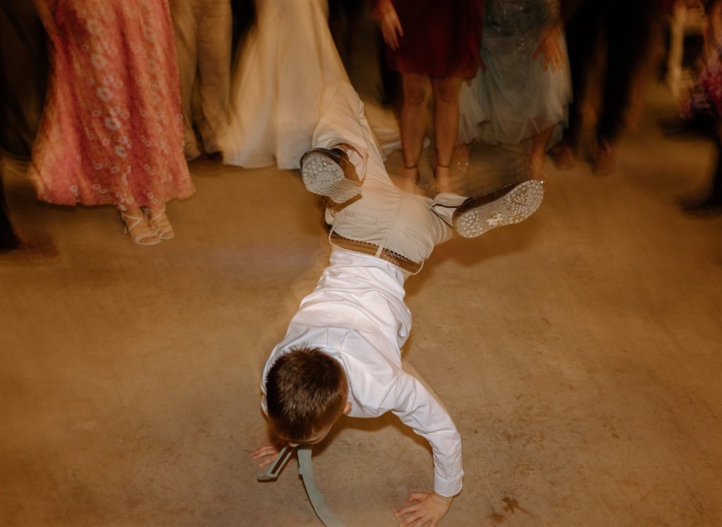 Kid break dances at Texas wedding reception.