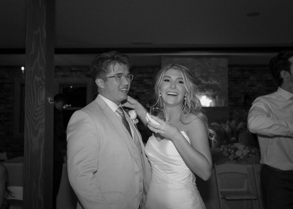 Bride and groom in black and white at wedding reception.