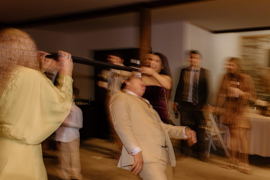 Groom limbos during texas wedding reception.