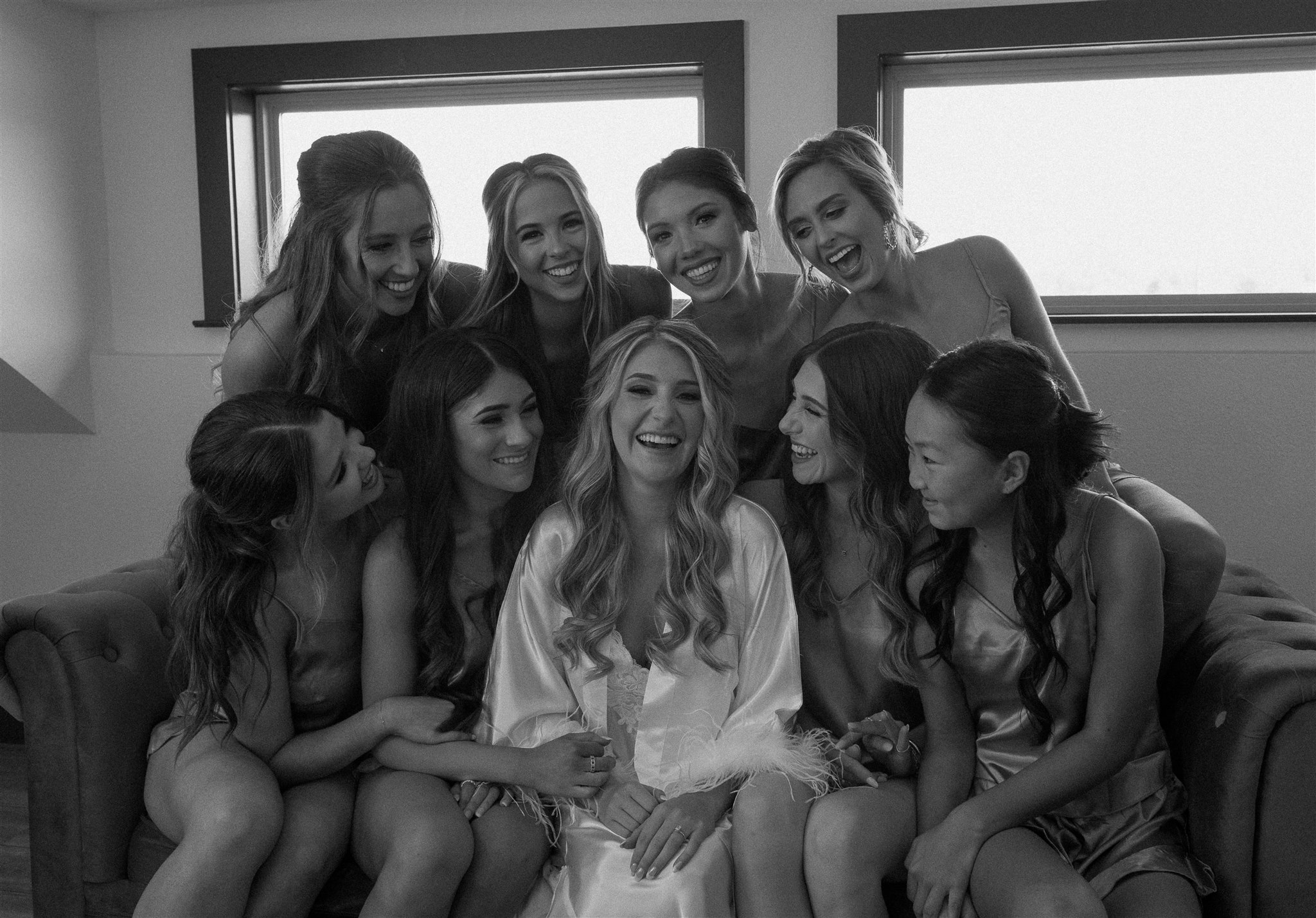 Bridal party laughs candidly while getting ready at Texas Wedding Venue.