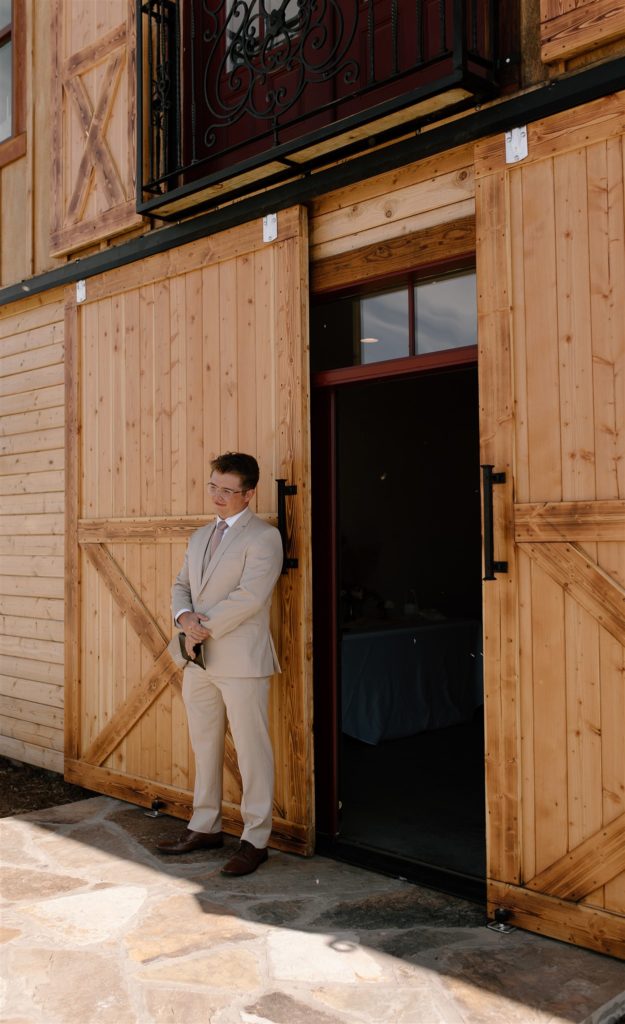 Groom waits for his bride before first touch at Texas wedding venue.