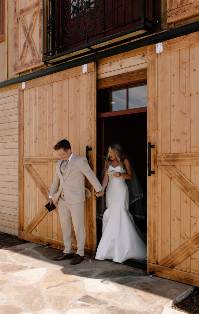 Bride holds hand of Groom during first touch at texas wedding venue.