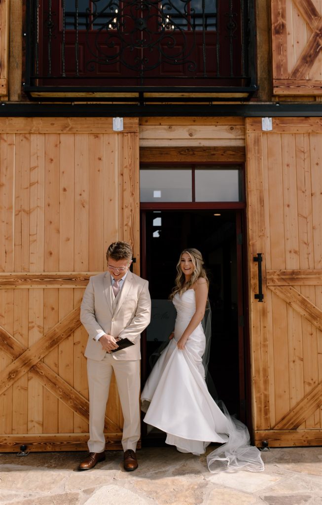 Bride smiles at camera as her first touch with the groom comes to an end.