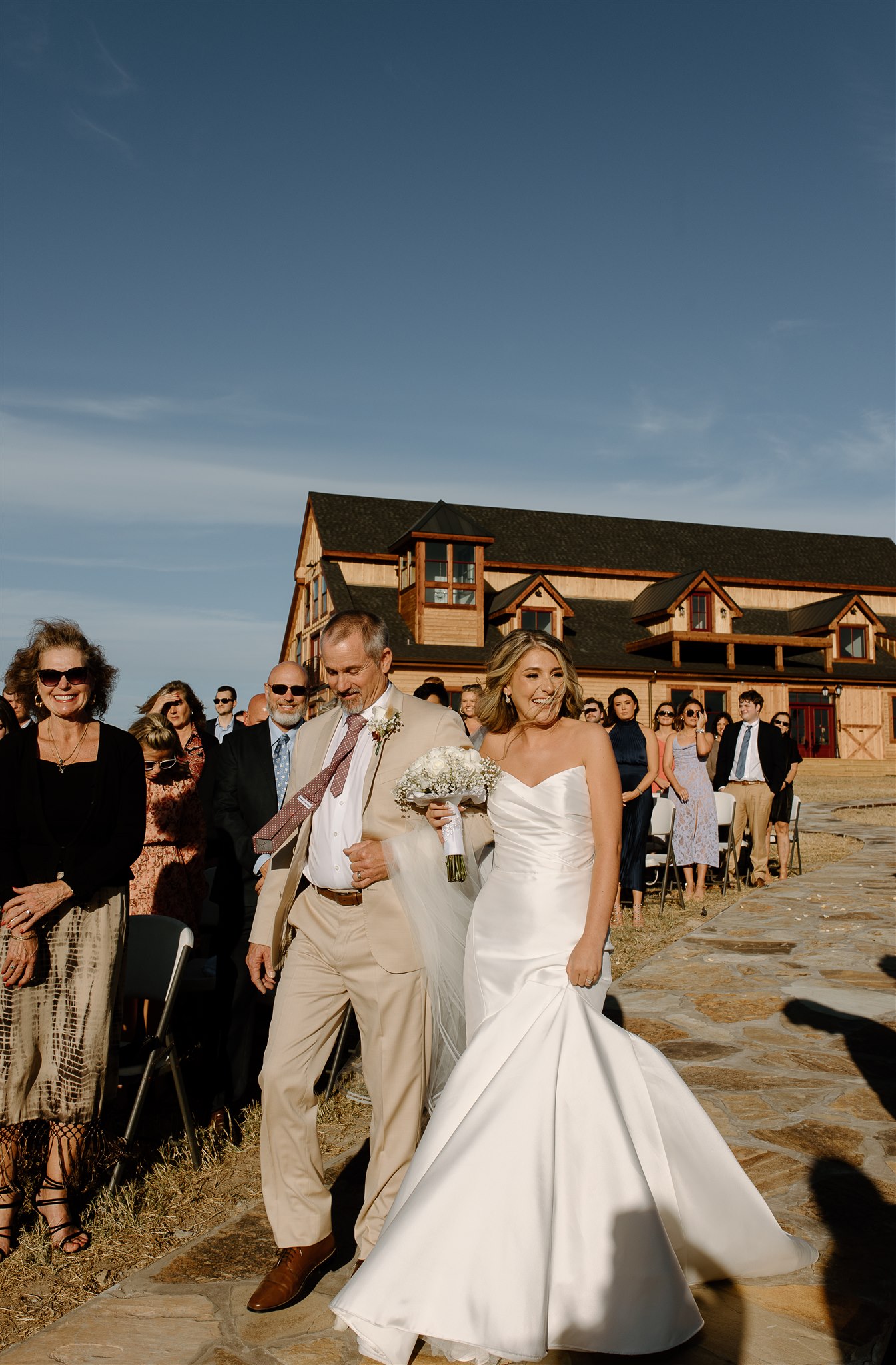 Bride smiles at wedding ceremony guests during texas wedding.