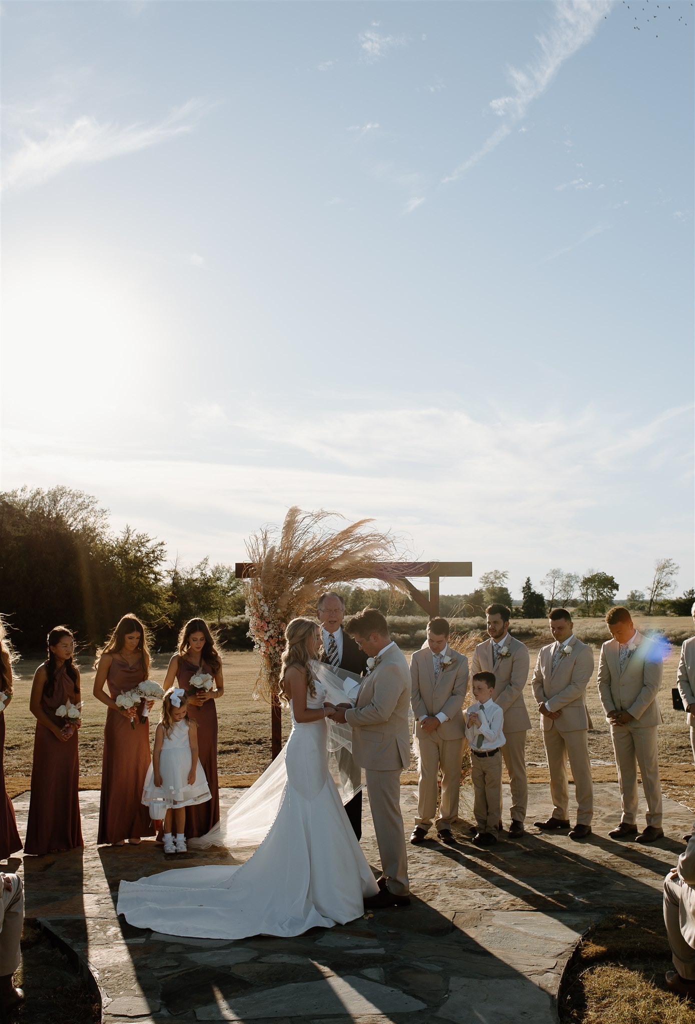 Bride and groom pray during texas wedding ceremony.