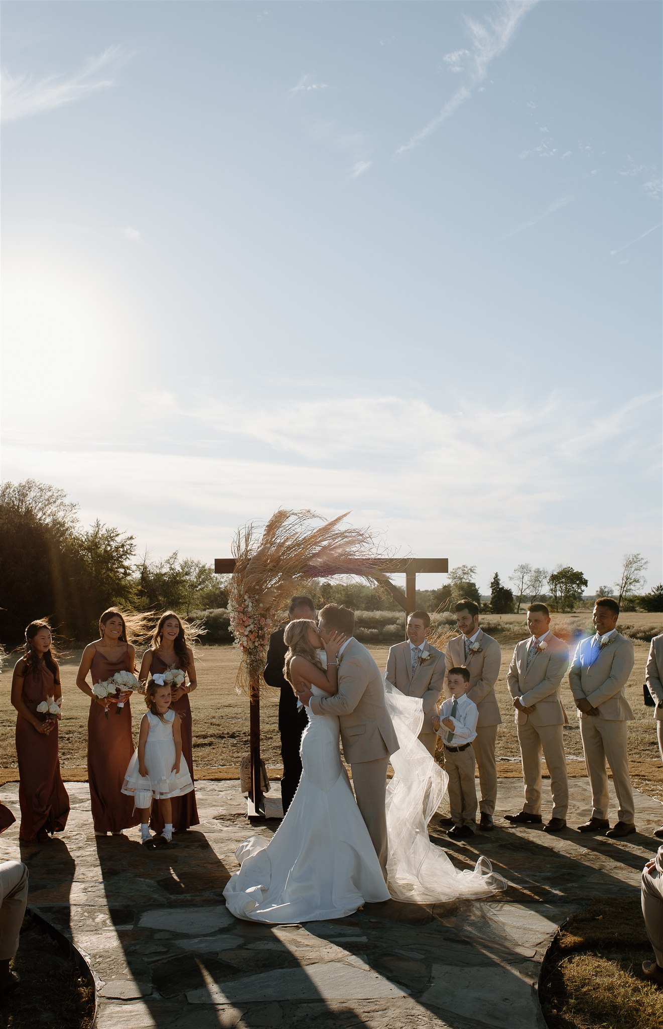 Emotional first kiss at the alter during texas wedding ceremony.