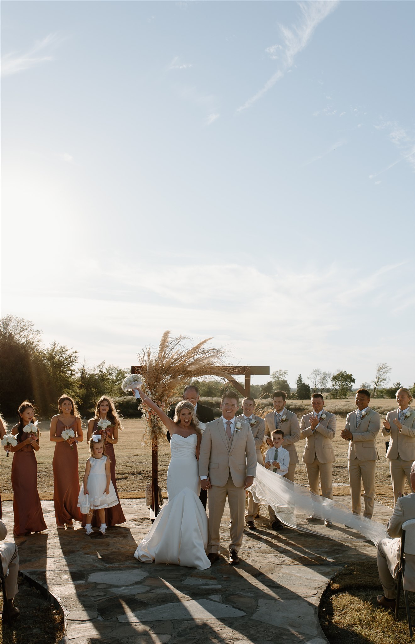 Bride and groom celebrates after first kiss during texas wedding ceremony.