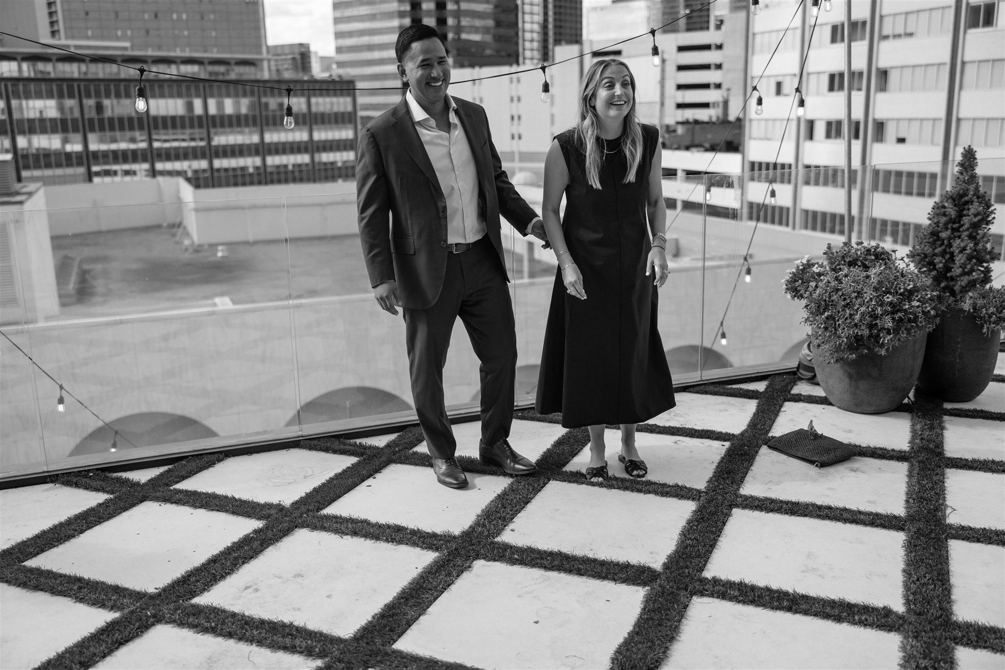 A couple is surprised by their family on the Thompson Hotel rooftop in Downtown Dallas.