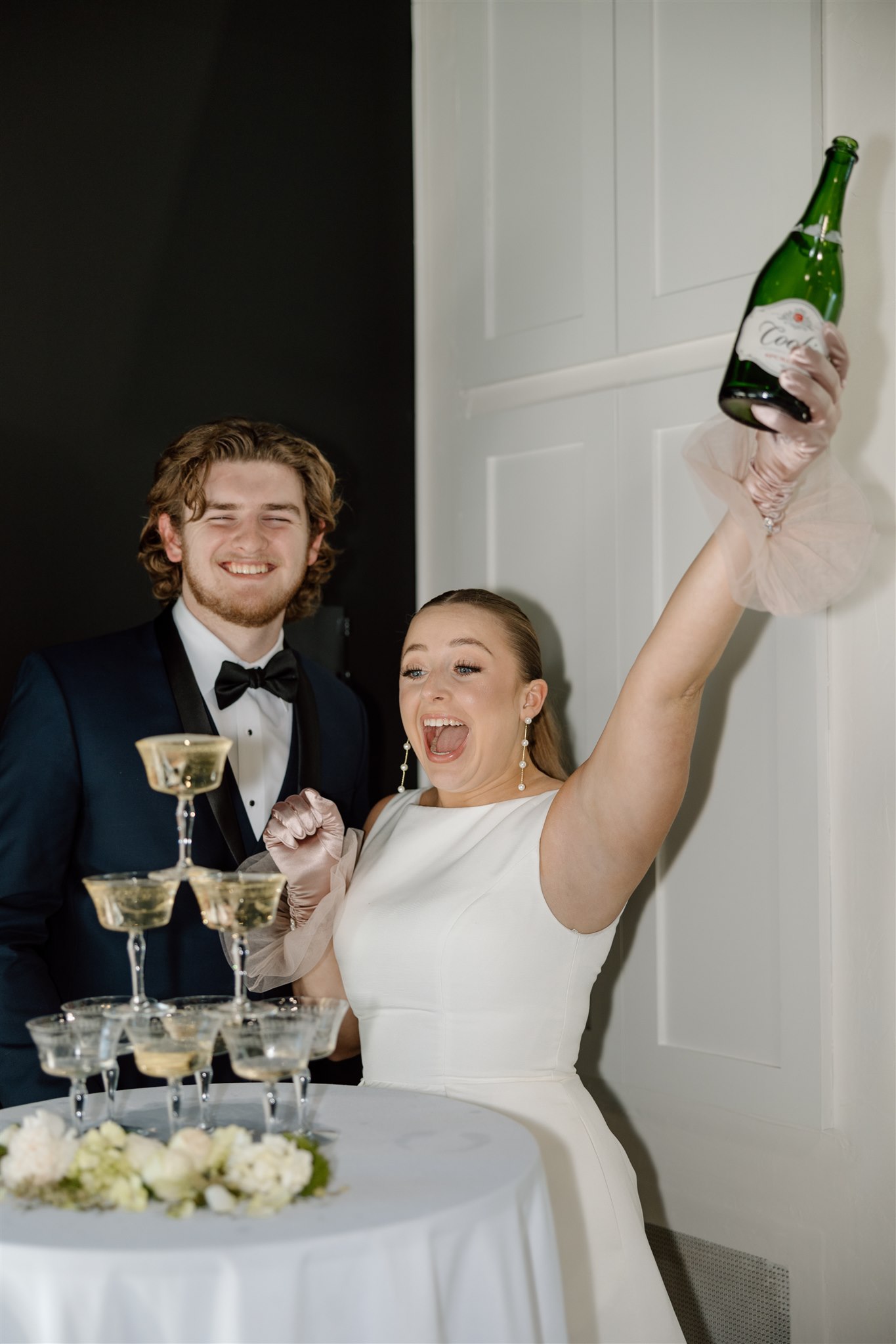 Bride and groom celebrate after their champagne tower pour at Briar Rose Venue.